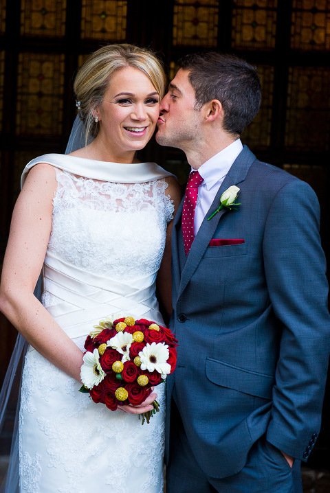 Stanhill Court Wedding Photographer - Groom kisses bride's cheek