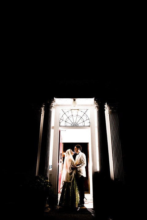 Bride and Groom BAcklit in Doorway at Capel Manor Gardens