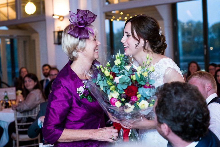 Bride gives Mum flowers