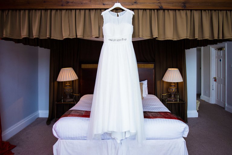  Dovecliff Hall Hotel Wedding Photographer - Wedding Dress hanging from four poster bed 