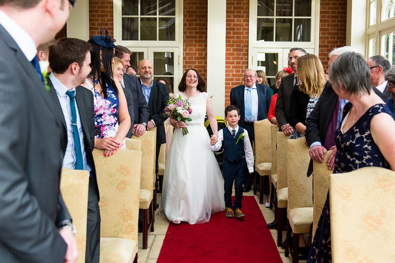 Bride walks down the aisle in The Orangery Room