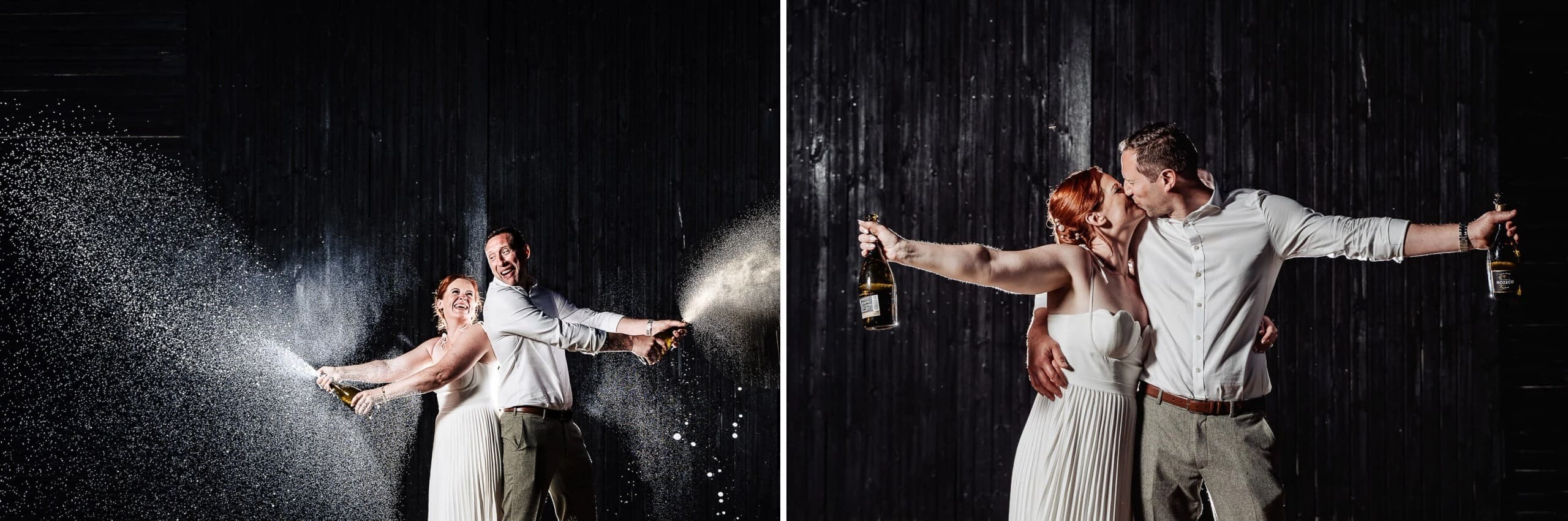 Bride and groom spraying champagne together in celebration, both arms extended outward with liquid arcing through air. — Wedding at Hunters Hall, Norfolk