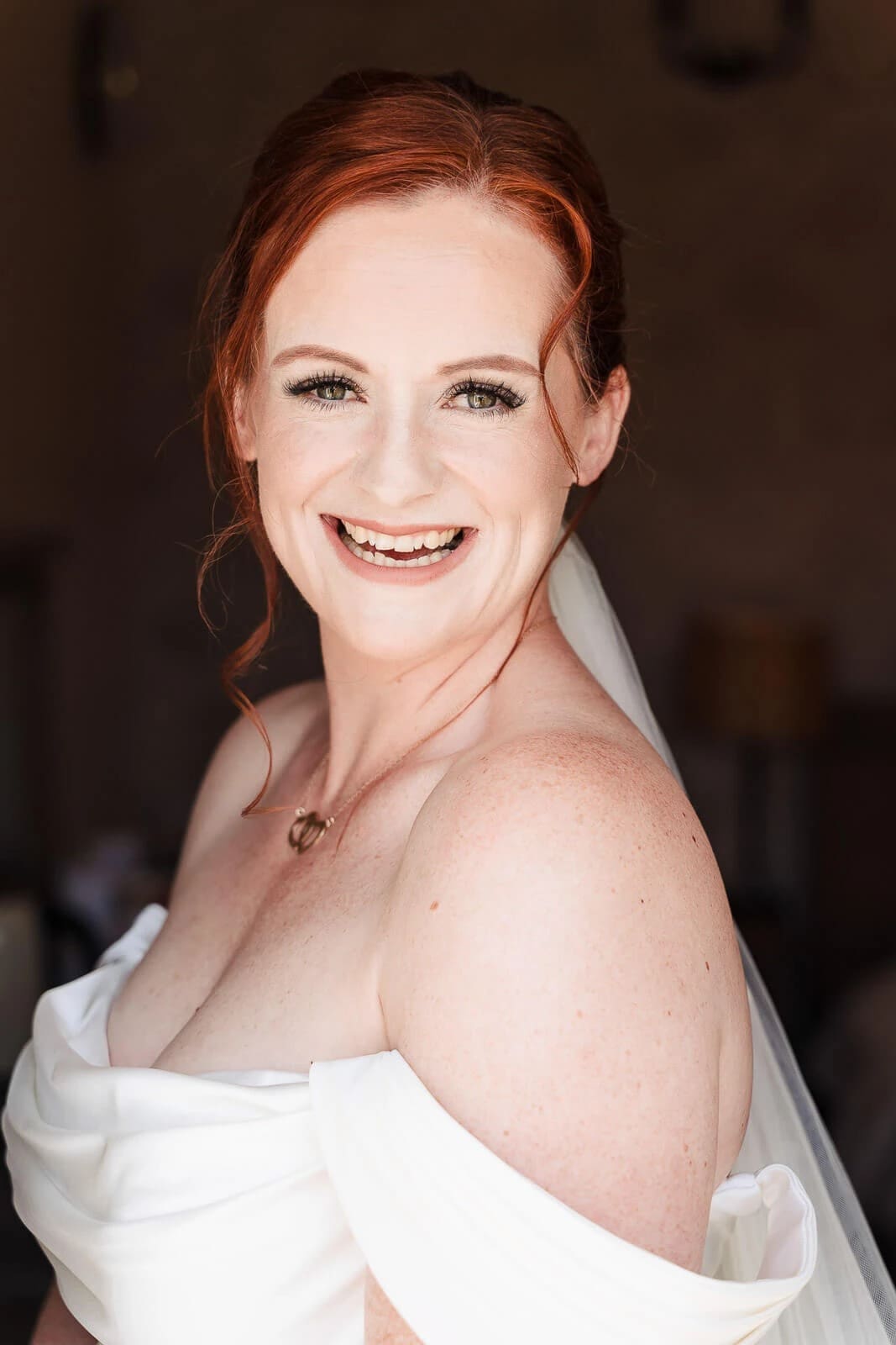 Woman smiling at camera over her shoulder in a portrait pose — Wedding at Hunters Hall, Norfolk