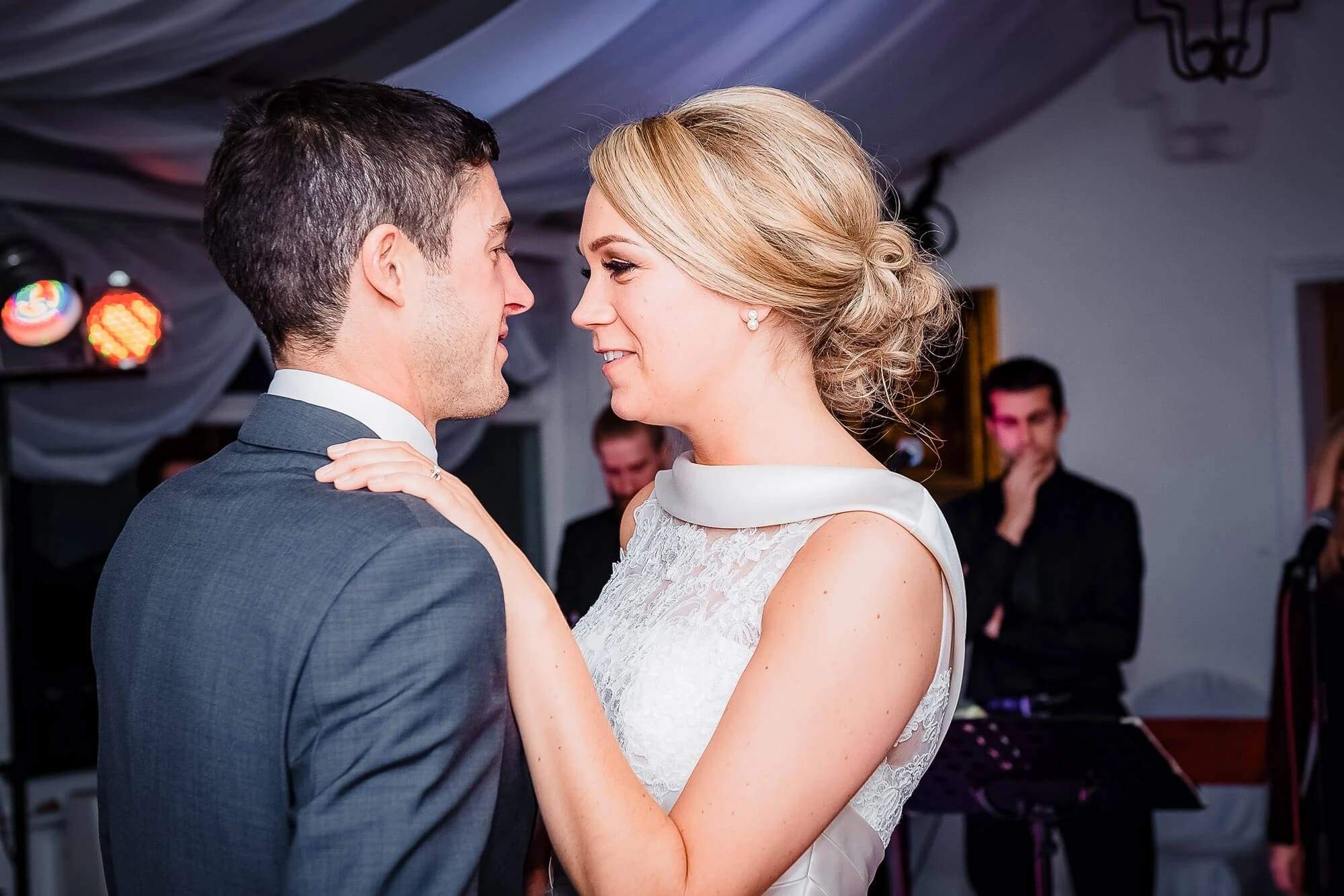 Couple dancing together at an indoor reception, facing each other closely. — Wedding at Stanhill Court Hotel, Surrey