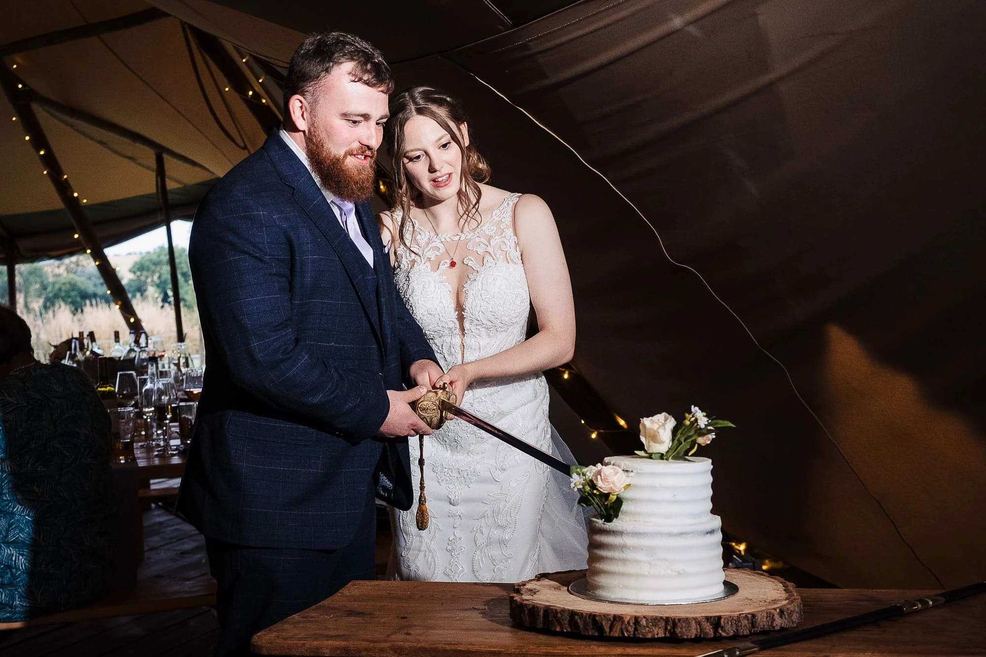 Bride and groom cutting their wedding cake together at reception. — Wedding at Moulton Parish Church, Northamptonshire