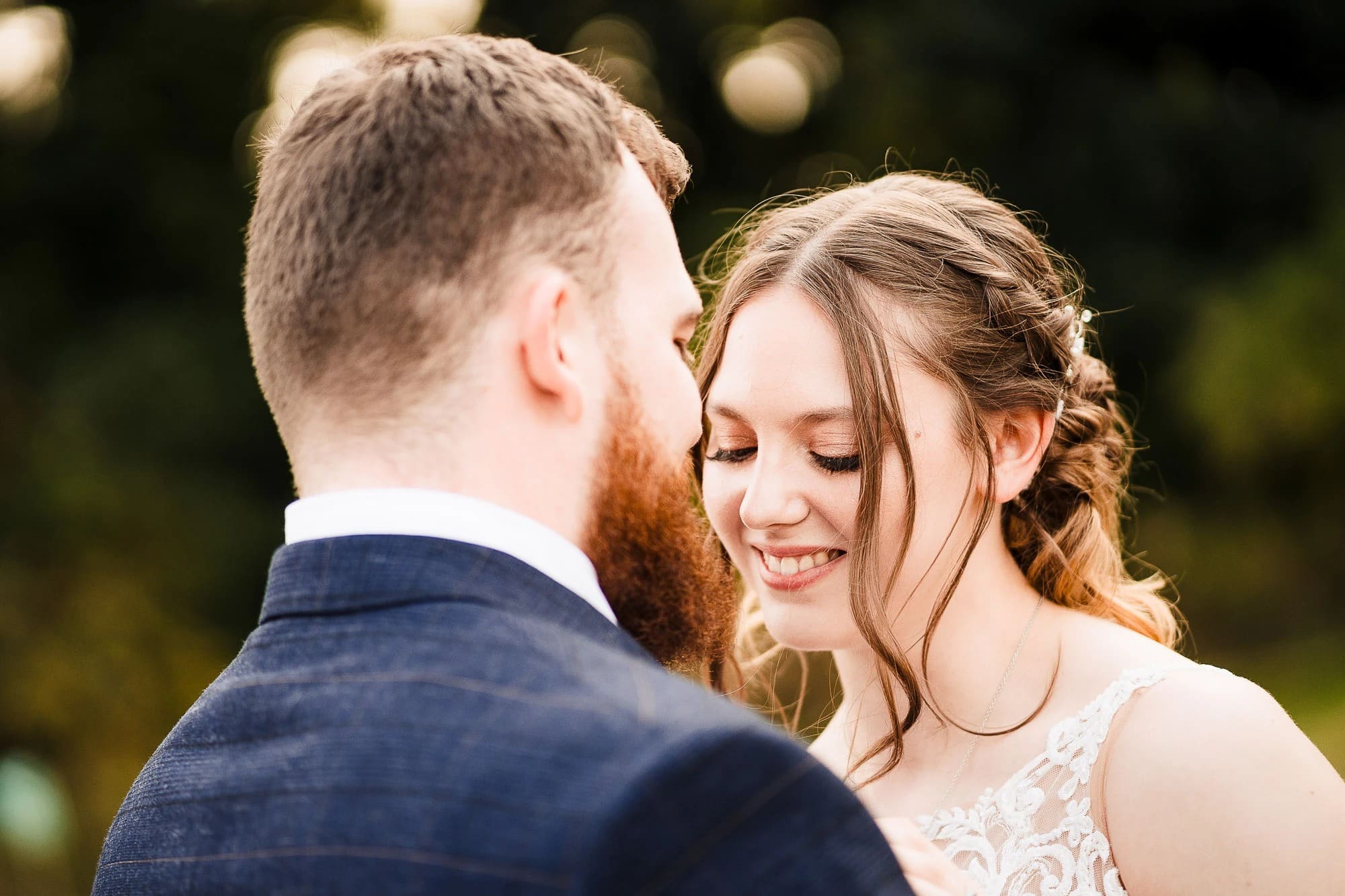 Bride and groom sharing an intimate moment, foreheads nearly touching, smiling at each other. — Wedding at Moulton Parish Church, Northamptonshire