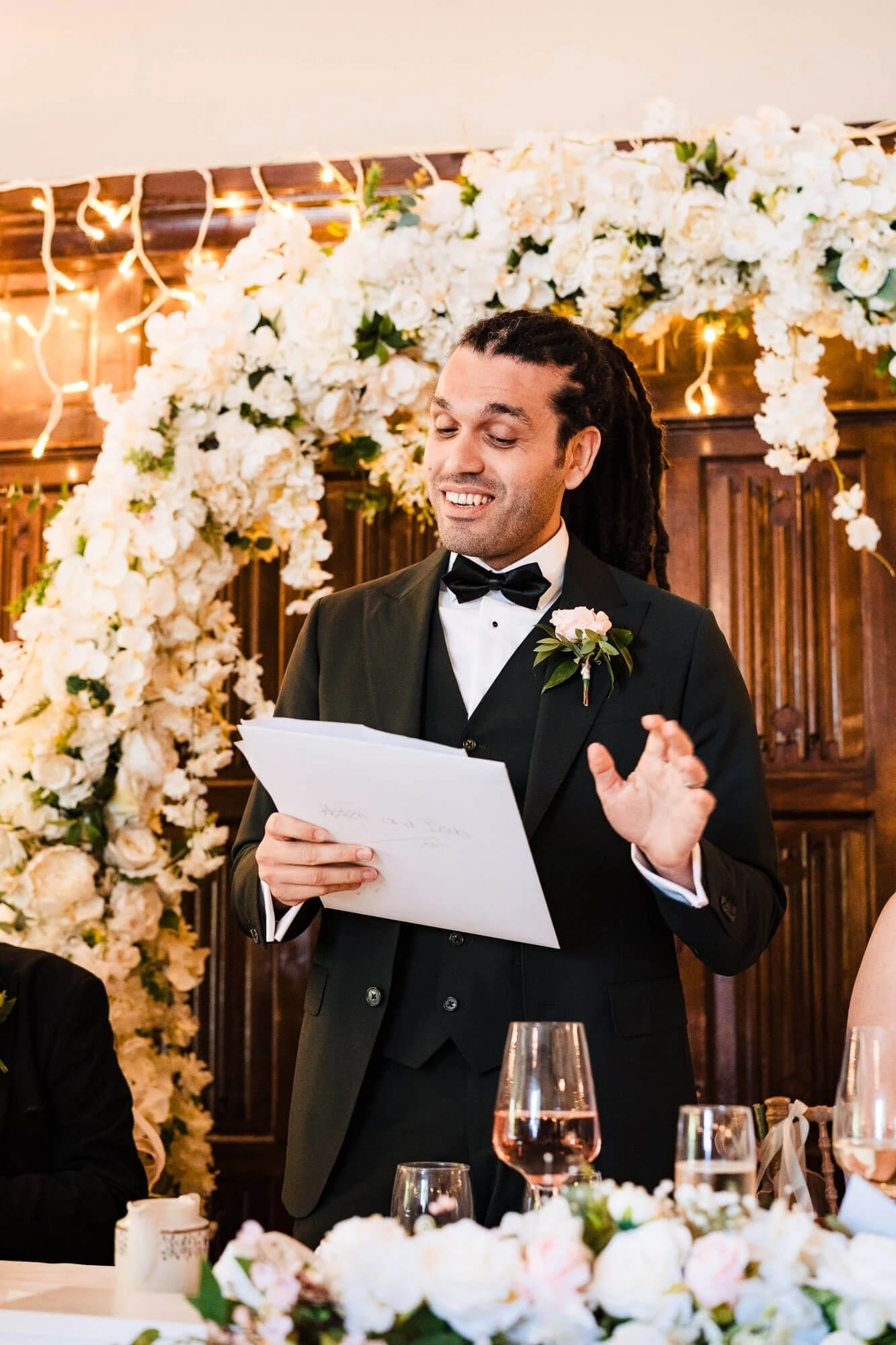 Groom giving a speech at the reception, holding a card and gesturing expressively. — Wedding at Sprowston Manor Hotel, Norfolk